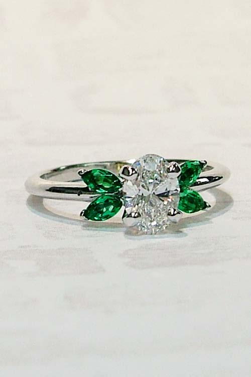 oval lab grown diamond and emerald marquise engagement ring