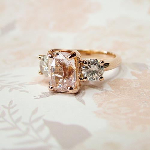 rose gold three stone engagement ring