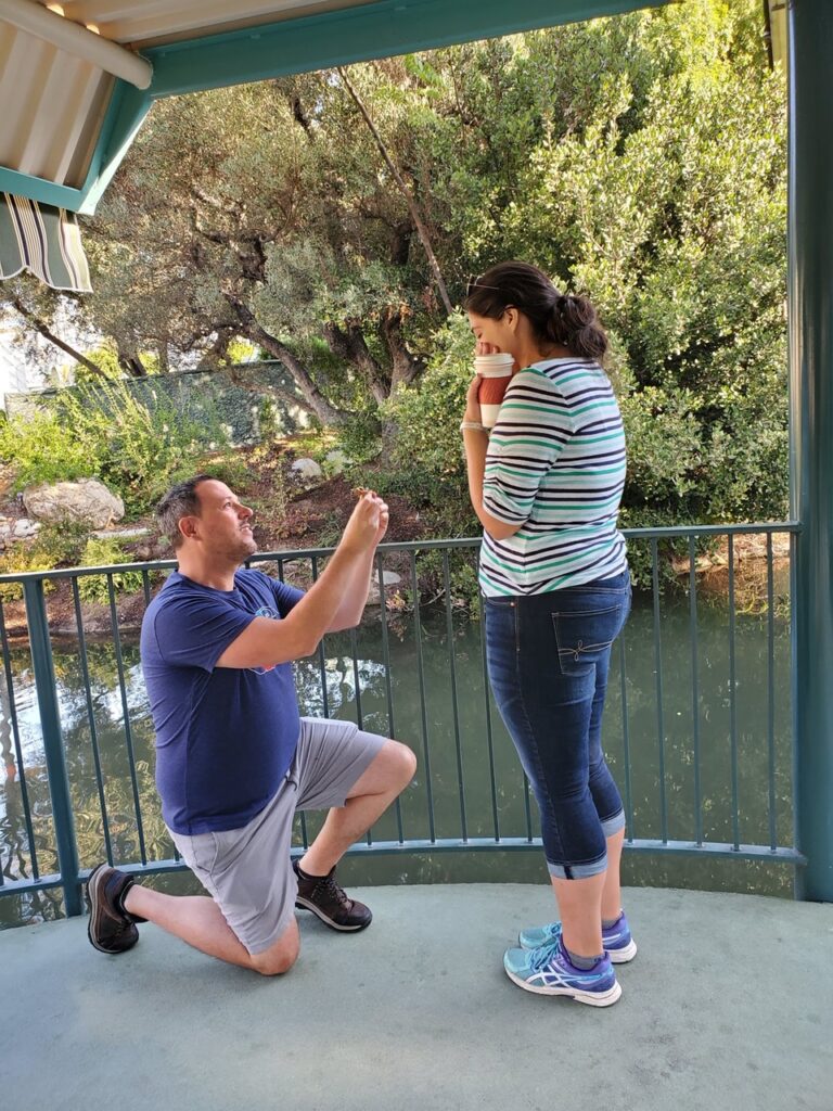 man proposes to a woman beside a river